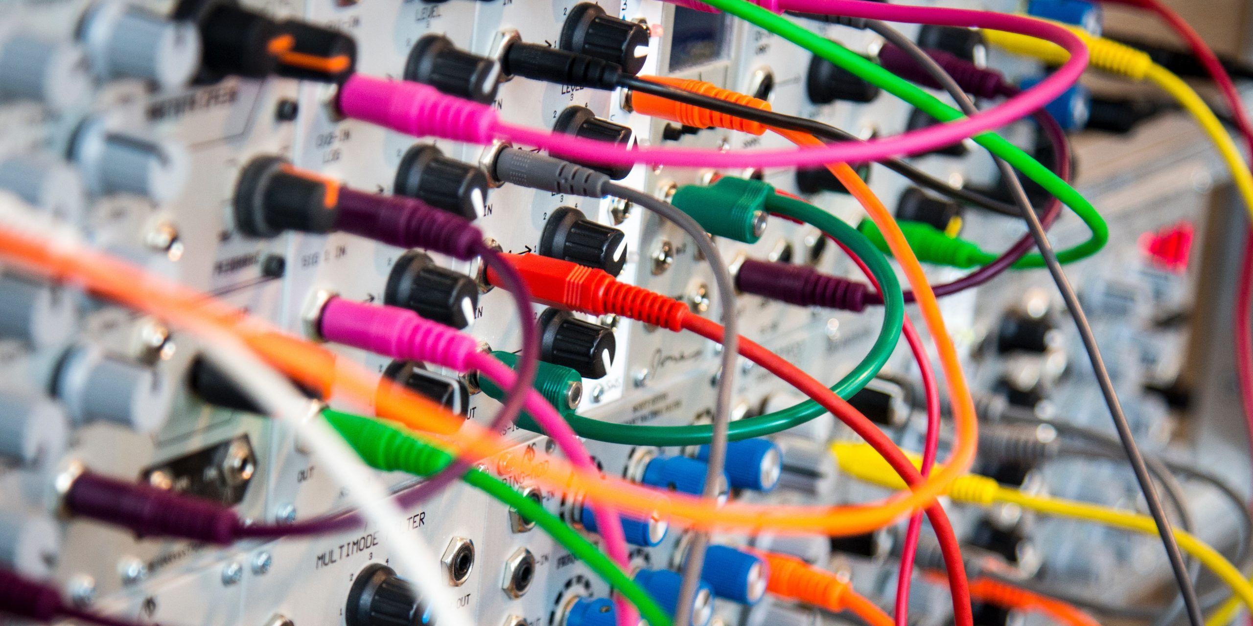 a complicated tangle of coloured wires plugged into a board