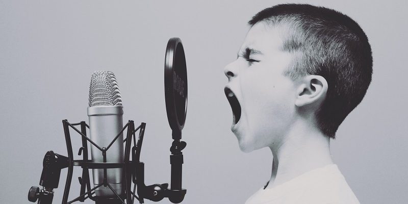 child shouting into microphone to make people listen